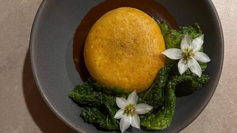 A dish from Los Felix garnished with edible flowers