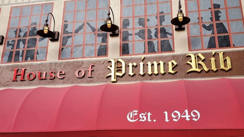 The outside of House of Prime Rib with its bright red awning