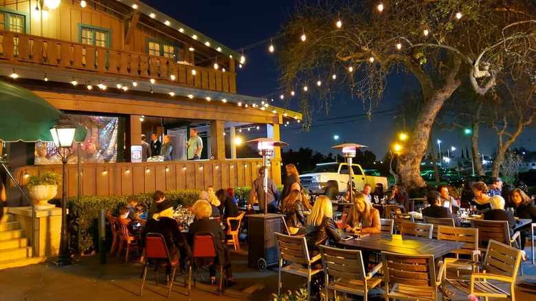 The patio of Sycamore Inn filled with people sitting at tables