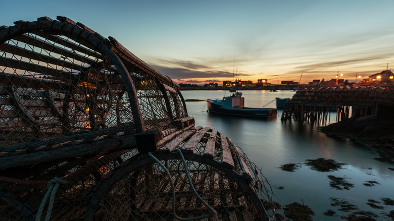 lobster traps stacked on a wharf at dawn