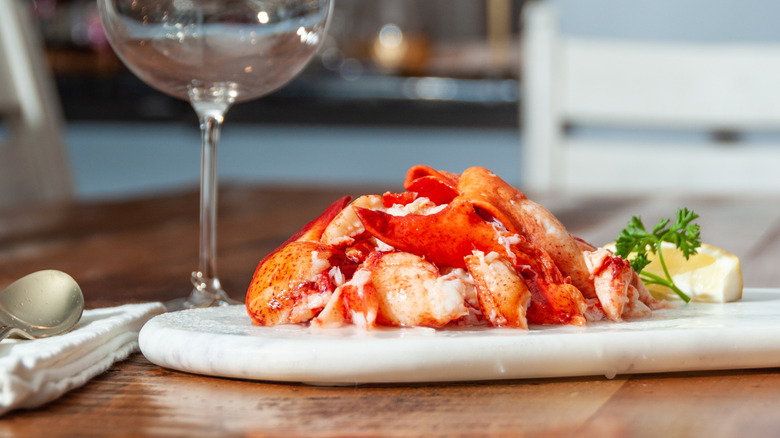 lobster meat on plate with lemon wedge