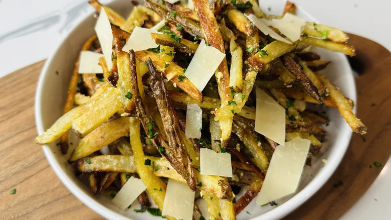 A white bowl of baked garlic parmesan fries