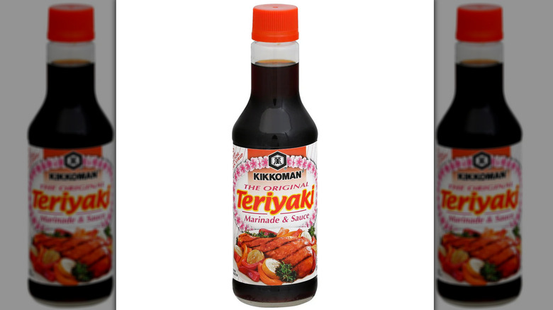 A bottle of Kikkoman teriyaki marinade and sauce against a white background