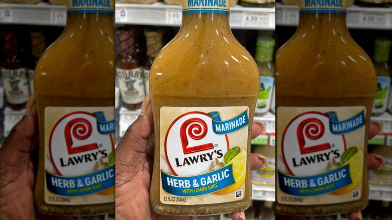 A person holding Lawry's marinade at the grocery store