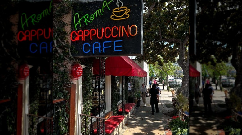 A neon sign outside Aroma cappuccino cafe