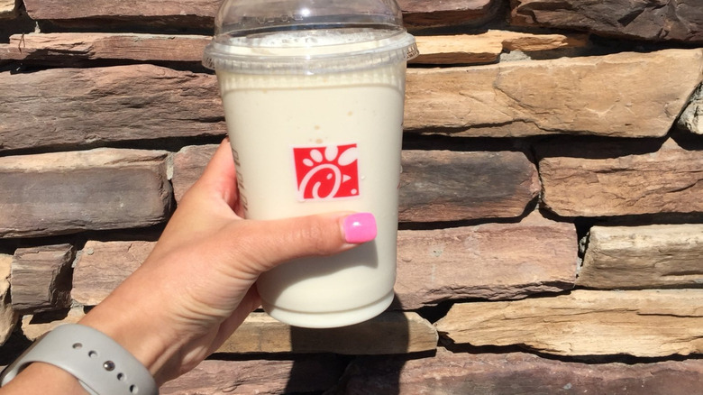 Frozen Peach Lemonade in front of a stone wall