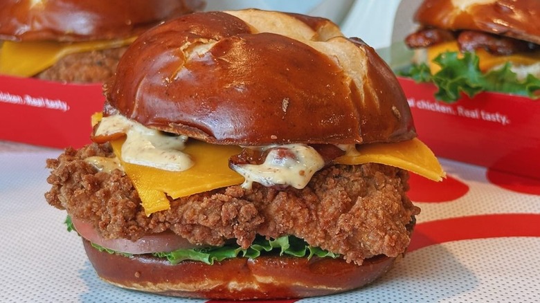 Pretzel Cheddar Club Sandwich with two sandwiches in the background