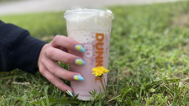 Strawberry Dream Refresher held on top of grass