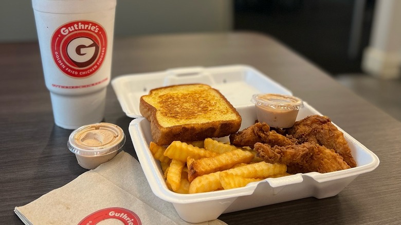 A snack combo from Guthrie's featuring chicken fingers, fries, Texas toast, and Guthrie's sauce, with a drink