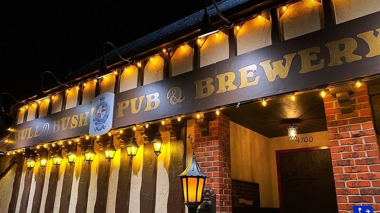 An exterior of Bull & Bush Brewery captured at night with moody lighting that gives it a warm ambiance