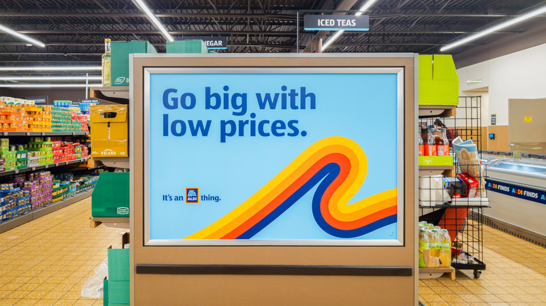 Sign that says "Go big with low prices" inside an Aldi store