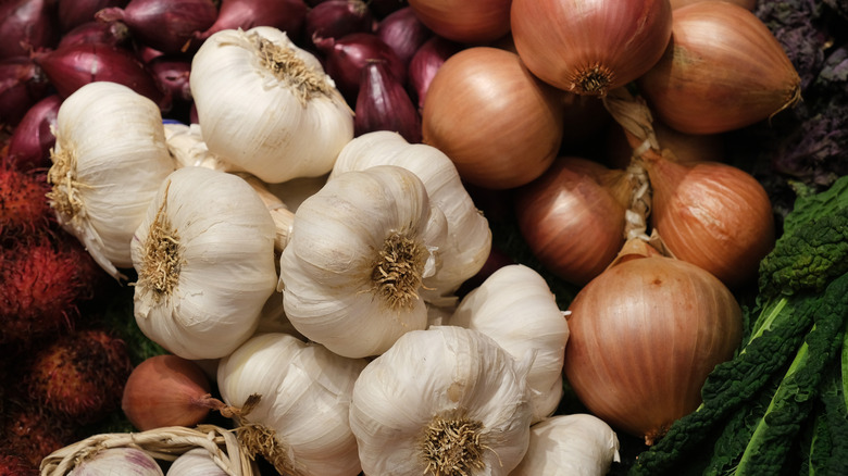 Pile of garlic bulbs and onions