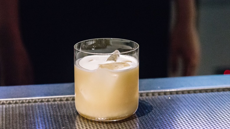 A creamy whiskey and Baileys Jack Knife cocktail sitting on a bar top.