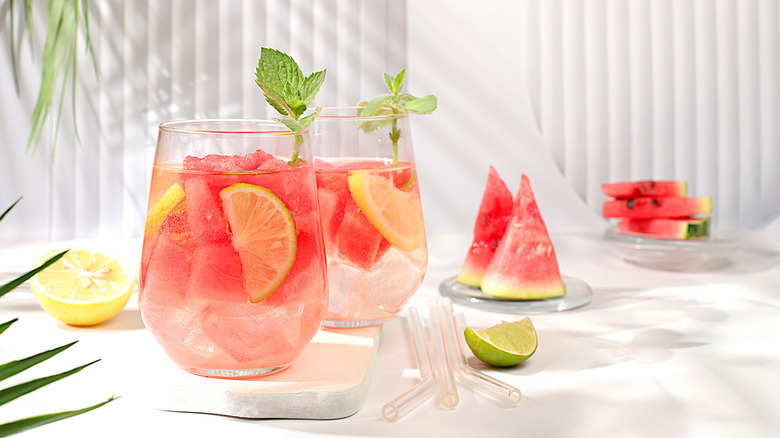 Two glasses with fruit drink on sunny table