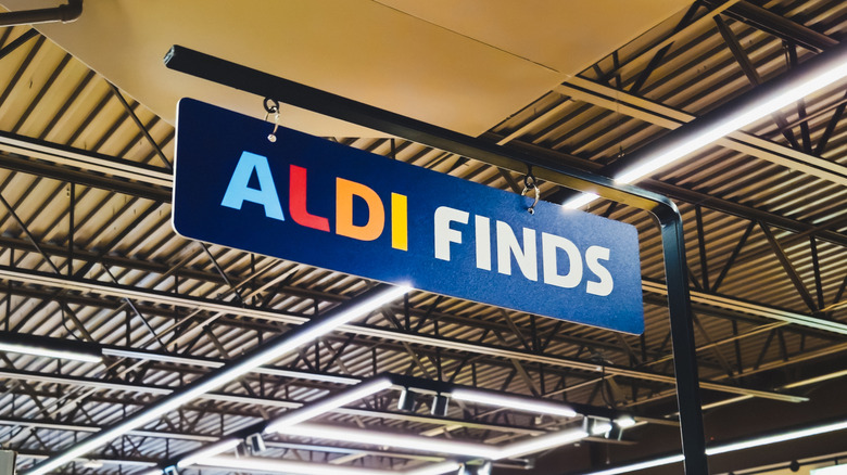 Aldi finds sign in store above section.