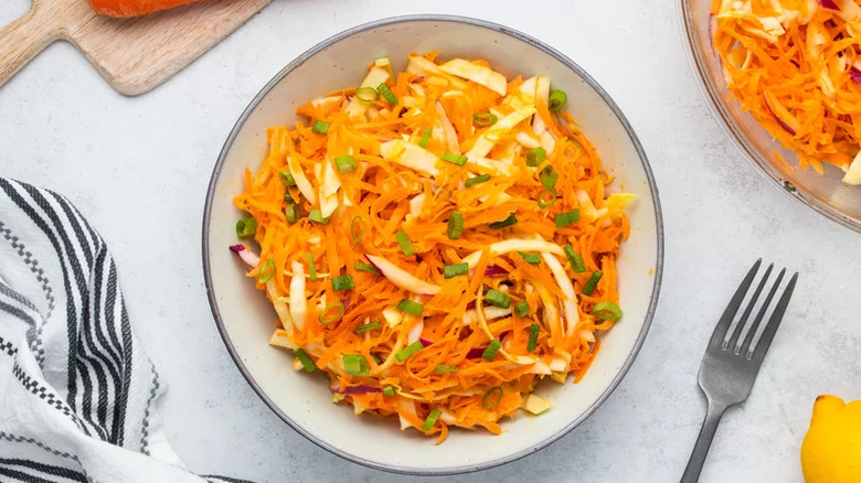 Carrot slaw in a bowl with onions