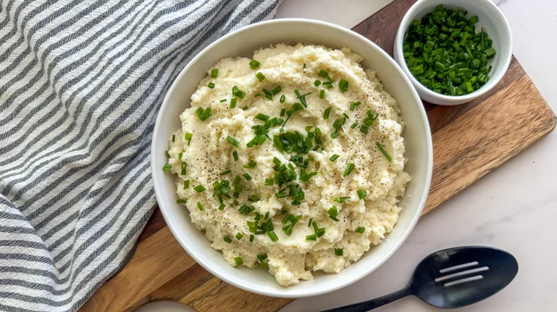 Bowl of creamy cauliflower mash with scallions