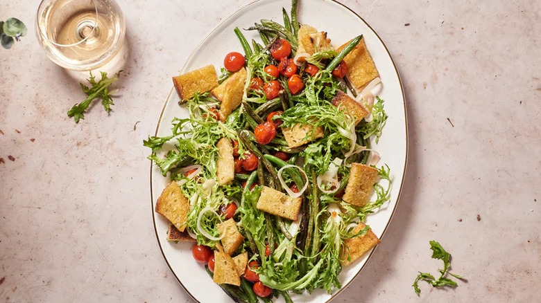 Dish with salad and a glass of wine