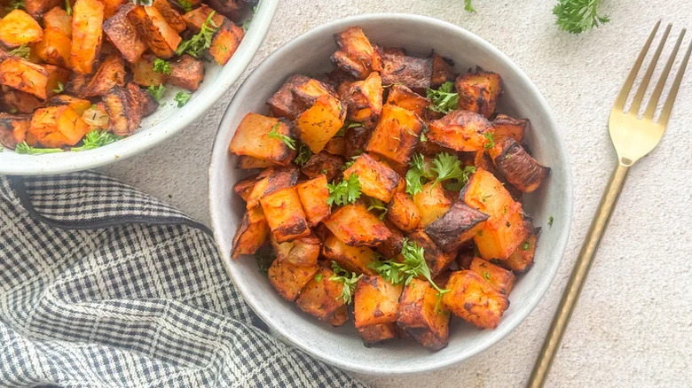 Roasted Spanish potatoes with a bowl