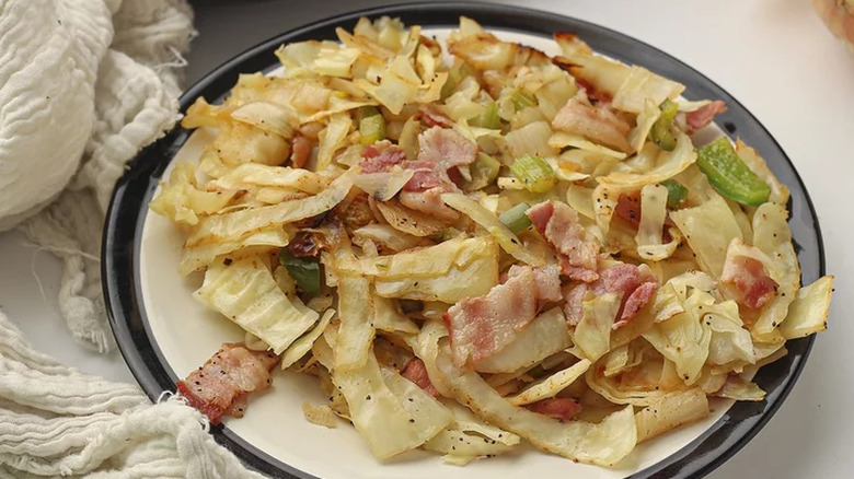 Fried cabbage with bacon on a plate