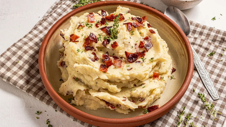 Bowl of mashed potatoes with a spoon