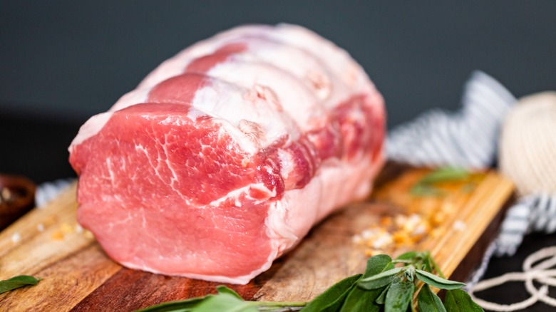 fresh pork tenderloin on cutting board