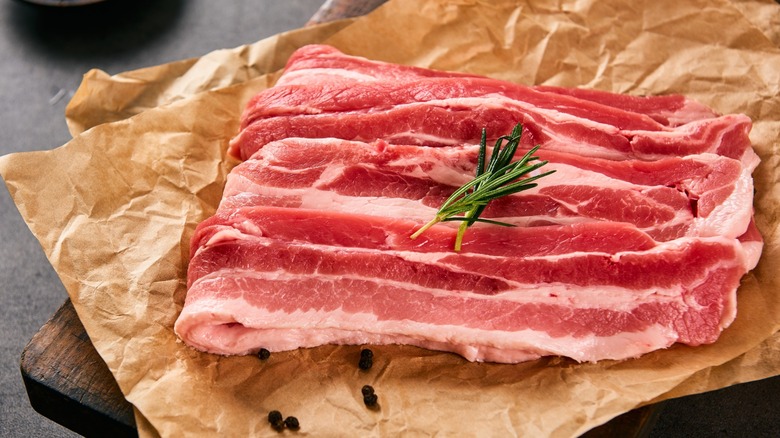 raw slabs of pork belly on parchment paper