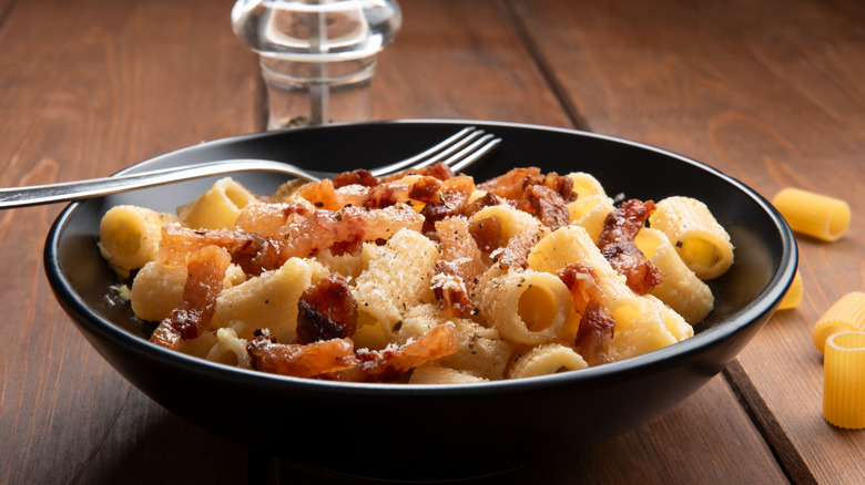 Pasta alla gricia served in a bowl with a fork.