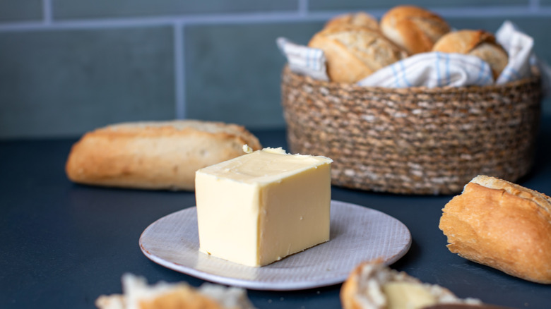 Block of butter with bread on side
