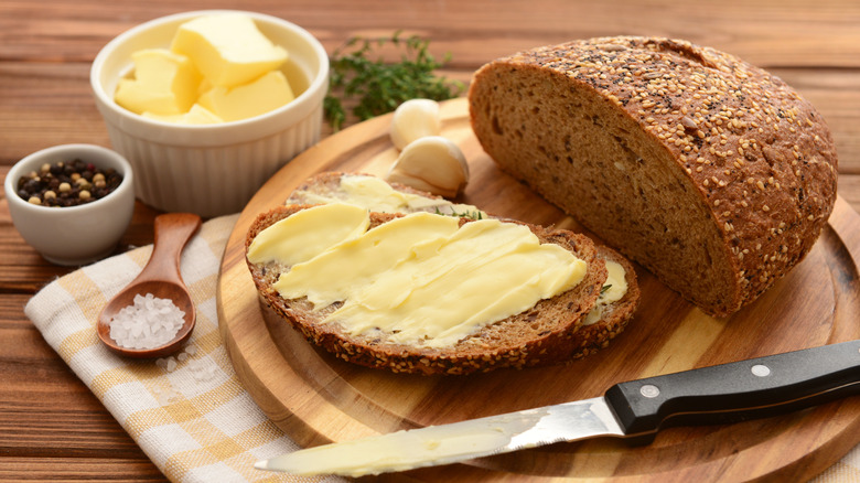 Bread on wooden plank with butter