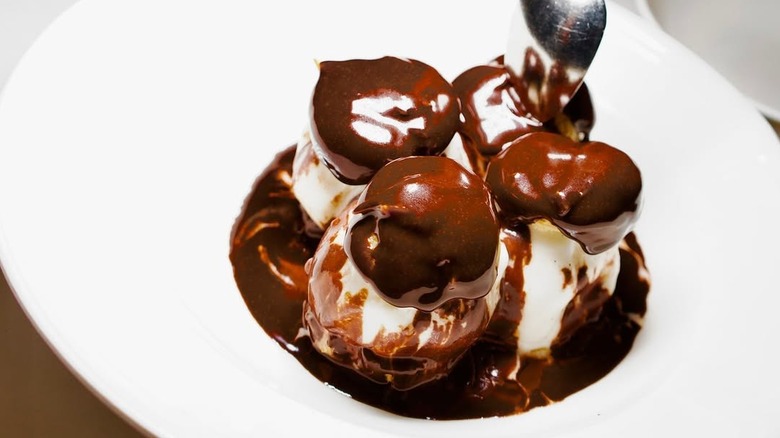 A spoon dips into a fancy dessert.