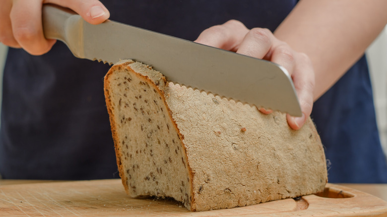 Serrated knife slicing bread