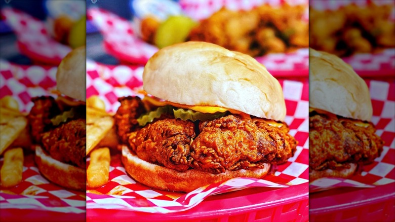 a hot chicken sandwich on checkerboard paper