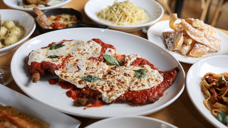 variety of Italian dishes on brown wooden table