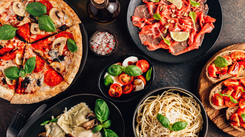 assortment of Italian meals on black table