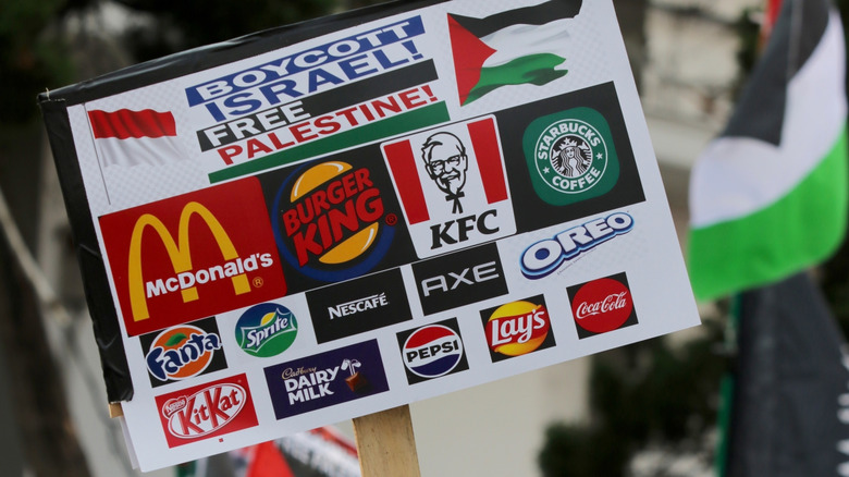 Pro-Palestinian protest sign calling for boycotts against Starbucks, KFC, and other brands