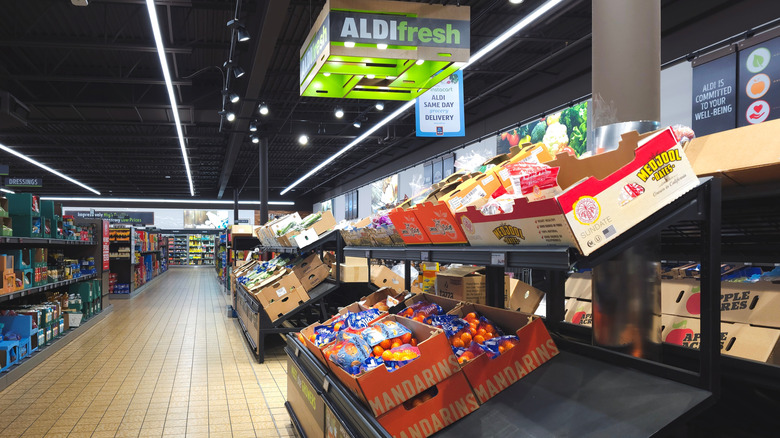 Shelves lined with boxes of produce at Aldi