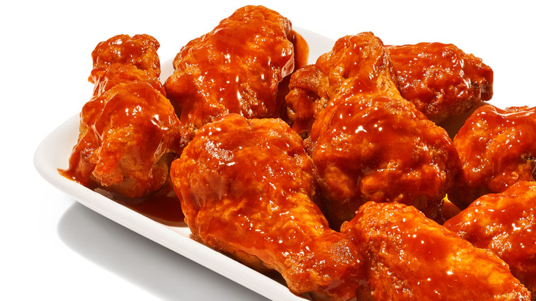 closeup of Domino's Hot Buffalo Wings on white tray on white background