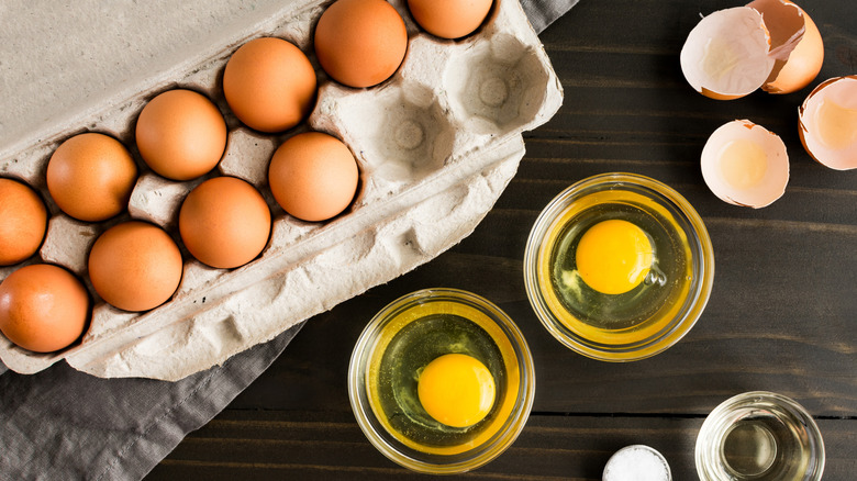Egg carton on table with baking ingredients