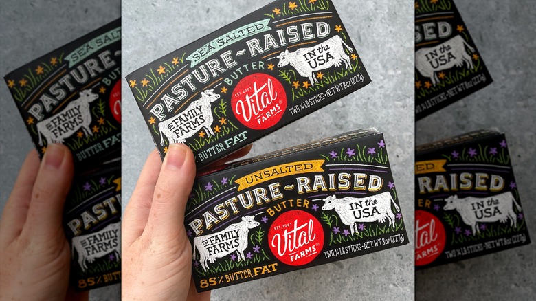 Person holding packs of butter