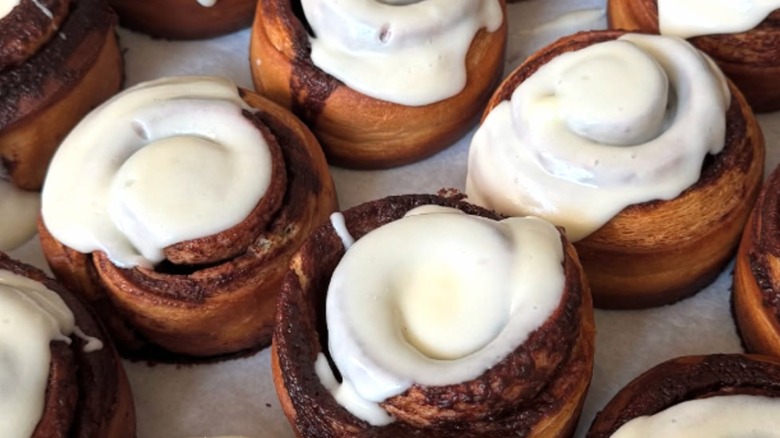 Tray of frosted cinnamon roll pastries