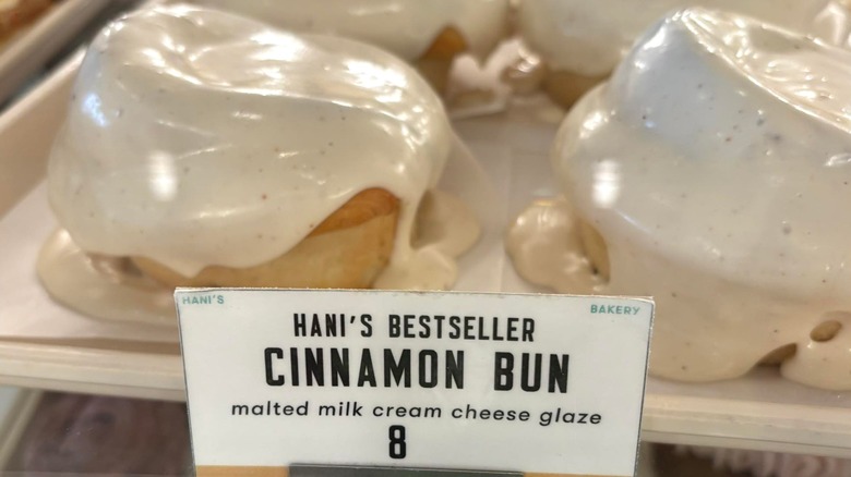 Gooey frosted cinnamon rolls on display tray