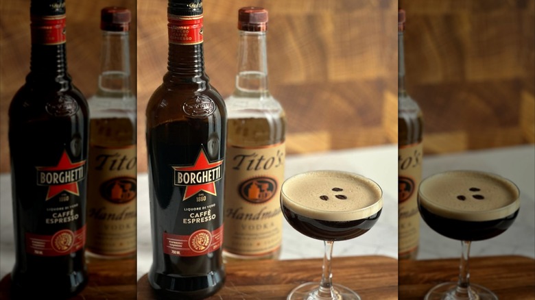 A bottle of Borghetti with an espresso martini in a glass with a bottle of Tito's vodka in background