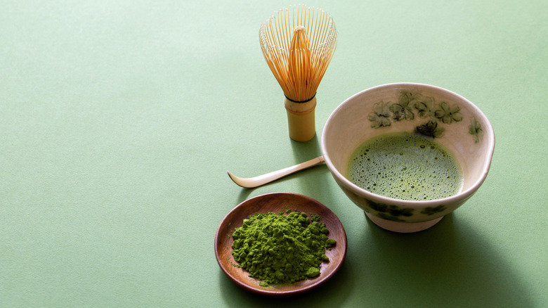Matcha preparation against a green background