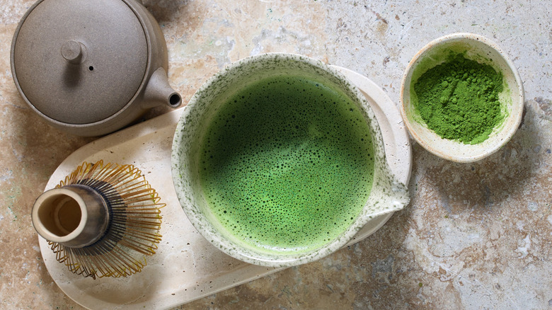 Matcha tea preparation on a stone counter