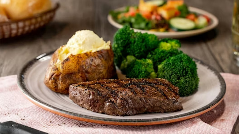 A sirloin steak with broccoli and a baked potato at Logan's Roadhouse