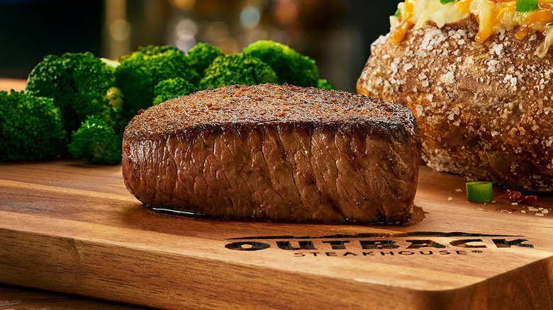 A sirloin steak on a cutting board at Outback Steakhouse