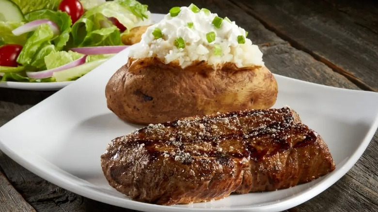 A sirloin steak with a baked potato at Sizzler
