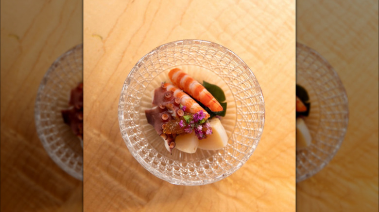 Garnished sashimi in an ornate bowl