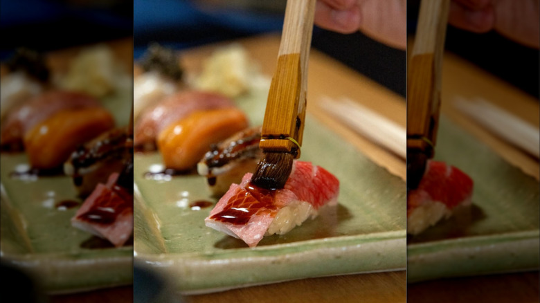 Painting sauce on sushi